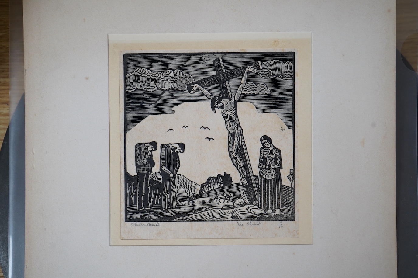 Ethelbert White (1891-1972), wood engraving on paper, 'The Christ', signed in pencil, 2/50, 13 x 13cm, unframed. Condition - some foxing and paper evenly discoloured, Sheet 17 x 17cm. Old card mount, tabbed at the top co